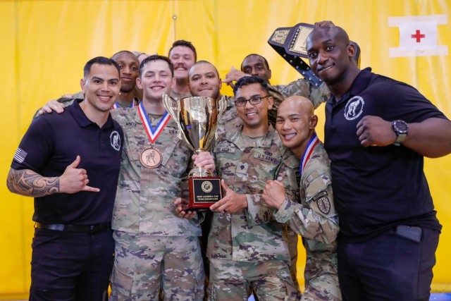 U.S. Army Soldiers assigned to XVIII Airborne Corps won the Team event at the Lacerda Cup at Sgt. 1st Class. Paul R. Smith Gym, Fort Benning, Georgia, April 13, 2023. Combatives training teaches Soldiers the rawest form of lethality - the ability to close with and destroy the enemy in close-quarters combat. Soldiers serve as the weapon, using their learned and mastered combatives skills to take down their opponents.(U.S. Army photo by Pfc. Summer Parish/ 50 Public Affairs Detachment)