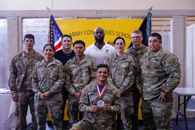 U.S. Army Soldiers assigned to the 3rd Infantry Division pose for a photo after the Lacerda Cup championship ceremony at Sgt. 1st Class. Paul R. Smith, April 13. 2023. The competition is designed to identify the top tactical team in the U.S. Army and assess the effectiveness of combatives programs of instruction. (U.S. Army photo by Pfc. Summer Parish/ 50 Public Affairs Detachment)