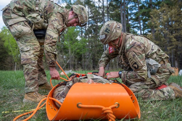 Capts. Matthew Cushing and Joseph Palazini from the 21st Brigade Engineer Battalion, Fort Campbell, Kentucky, request medical evacuation for a simulated casualty April 23, on the Medical Stakes Lane at Training Area 606.