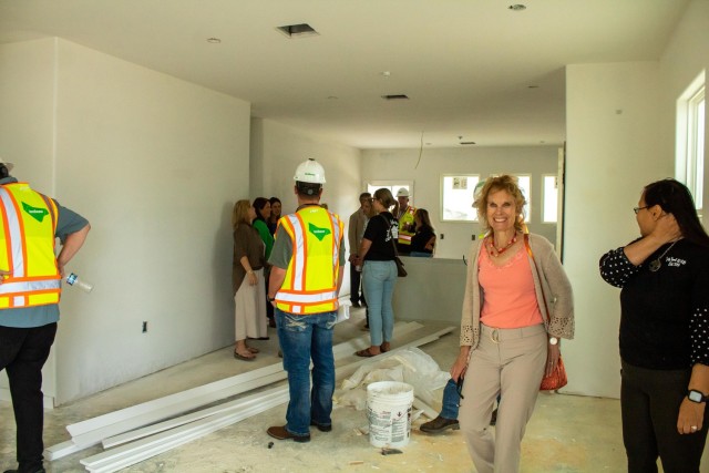 Maria McConville, Army veteran and registered dietitian, smiles as she takes in a new home being built in Chaffee Village April 20, 2023, in Fort Hood, Texas. (U.S. Army photo by Samantha Harms, Fort Hood Public Affairs)