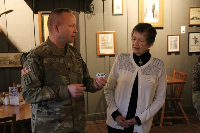 Col. Daniel Bridon Reynolds Army Health Clinic Commander presents Mrs. Rose Ann &#34;Cathy&#34; Herritt his Commander’s coin of excellence for her service as a volunteer with the Red Cross Service to the Armed Forces.