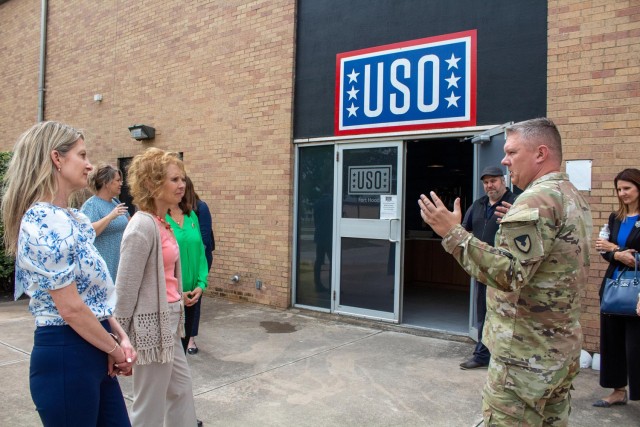 Deanie Richardson, spouse of Maj. Gen. John Richardson, 1st Cavalry Division commanding general, and Maria McConville listen as Col. Chad R. Foster, U.S. Army Garrison-Fort Hood commander, describes what the USO does April 20, 2023, at Fort Hood,...