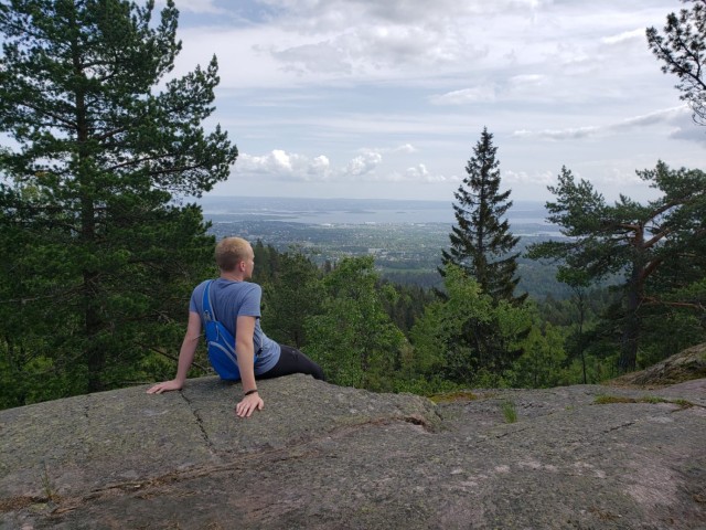 Ethan Flower, stepson of Sgt. Maj. Timothy Ferraro, Signal Leader Development College at Fort Gordon, Georgia, takes in a view at the peak of a hike in Norway.