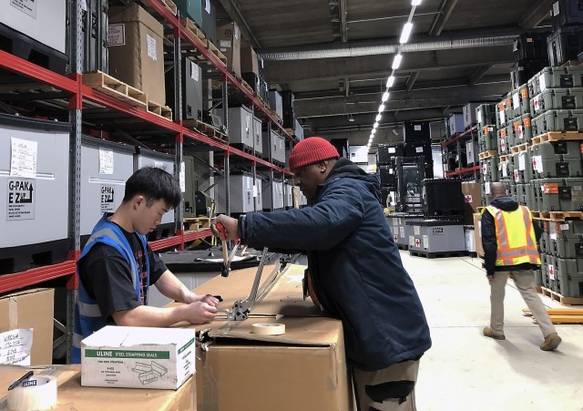 Cpl. Thien Nguyen, left, medical supply technician with the 551st Medical Logistics Company, and Karl Posley, a general supply specialist with the U.S. Army Medical Materiel Agency, prepare shipments of medical supplies at the Army pre-positioned stocks site July 1, 2022, in Germany.