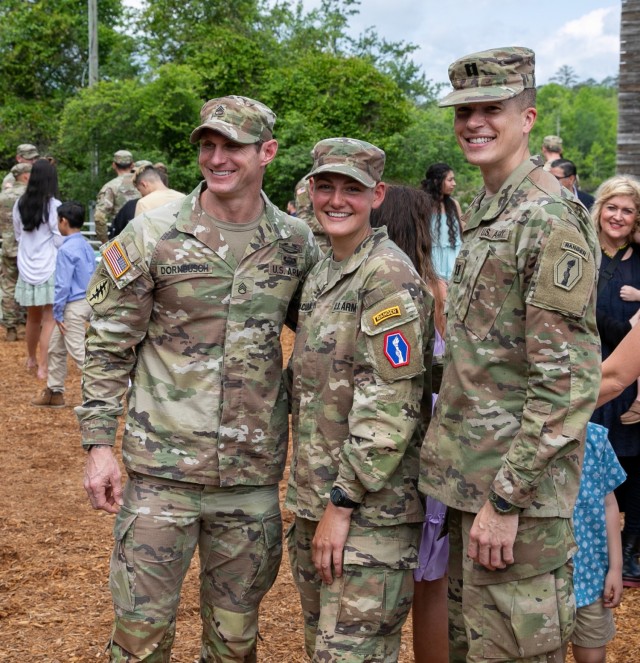 1st Lt. Anna Zaccaria (center) poses with her mentor SSG Jeremy Dornbusch (left) and Cpt. Ignacio Naudon (right) while celebrating after her Army Ranger School graduation ceremony at Fort Benning, GA, April 28, 2023.