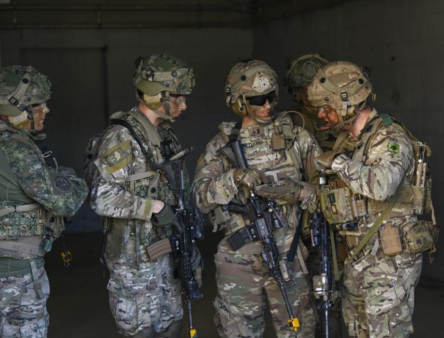 American, British and Dutch officers discuss next moves during Army Expeditionary Warrior Experiment 23 at Fort Benning, Georgia.