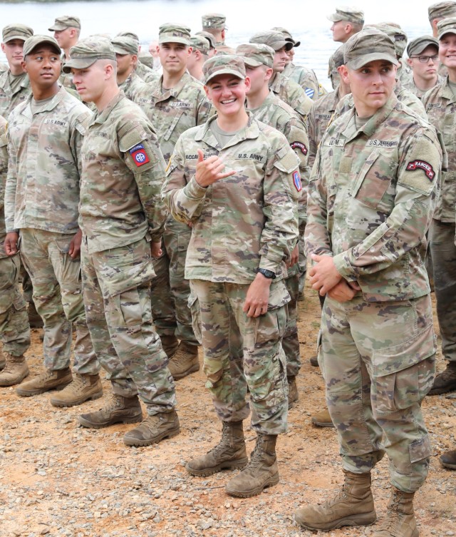 1st Lt. Anna Zaccaria, 100th Battalion, 442nd Infantry, (center) gives a Hawaiian ‘Shaka’ while waiting for her Army Ranger School graduation ceremony to begin at Fort Benning, GA, April 28, 2023.