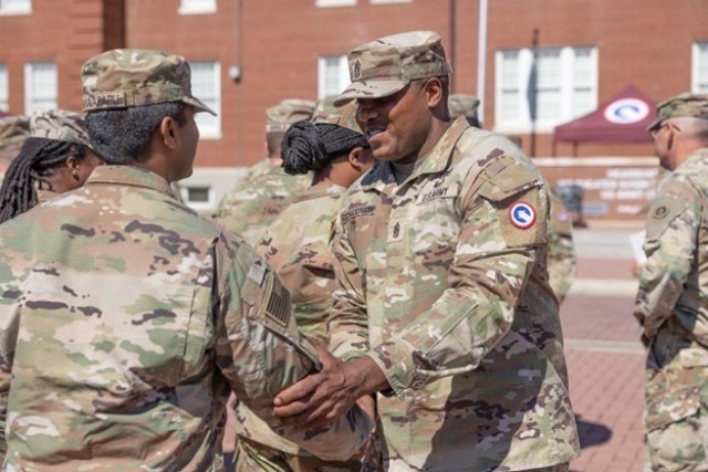 Command Sgt. Maj. Albert E. Richardson Jr., senior enlisted advisor, 1st Theater Sustainment Command, shakes hands with Soldiers from the 18th Financial Support Center who are preparing to deploy Oct. 5, 2022, at Fort Knox, Kentucky.