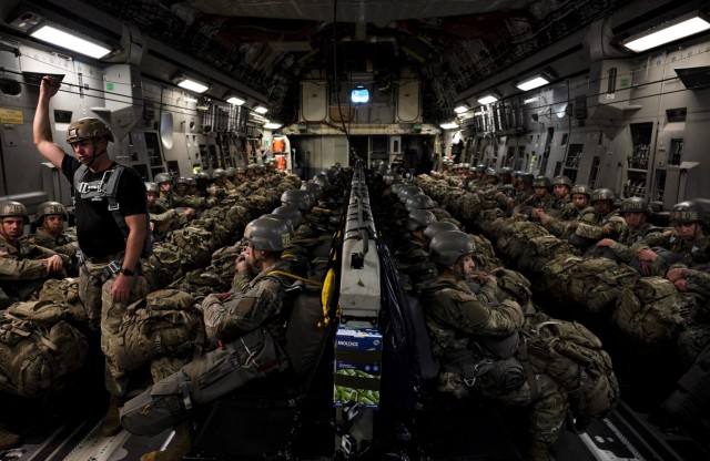 Airborne students ride in a C-130 cargo aircraft as they prepare fortheir third jump during the Basic Airborne Course at Fort Benning, Georgia, March 30. The three-week course teaches service members from every military branch how to safely conduct airborne operations.