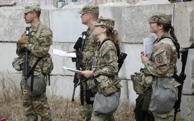 Reynolds Army Health Clinic Expert Field Medical Badge candidates review the requirements for one of the Combat Testing Lanes. Picture from left to right: Sgt. Ryan DeForest, Sgt. 1st Class Timothy McCoole, Capt. Courtney Livoti, Capt. Taylor Matsinger.