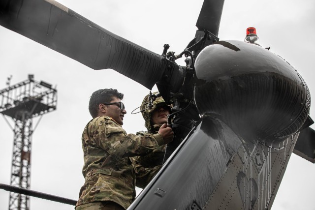 U.S. Soldiers assigned to the 3rd Combat Aviation Brigade, supporting the 4th Infantry Division, unfold the tail rotor blades on a UH-60 Blackhawk at the Port of Riga, Latvia, April 26, 2023. The 4th Infantry Division’s mission in Europe is to engage in multinational training and exercises across the continent, working alongside NATO allies and regional security partners to provide combat-credible forces to V Corps, America’s forward deployed corps in Europe. (U.S. Army photo by Spc. Williams Thompson, 1st Armored Division Combat Aviation Brigade)