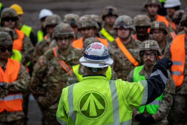 U.S. Soldiers assigned to the 3rd Combat Aviation Brigade, supporting the 4th Infantry Division, listen to instructions during port operations at the Port of Riga, Latvia, April 26, 2023. The 4th Infantry Division’s mission in Europe is to engage in multinational training and exercises across the continent, working alongside NATO allies and regional security partners to provide combat-credible forces to V Corps, America’s forward deployed corps in Europe. (U.S. Army photo by Spc. Williams Thompson, 1st Armored Division Combat Aviation Brigade)