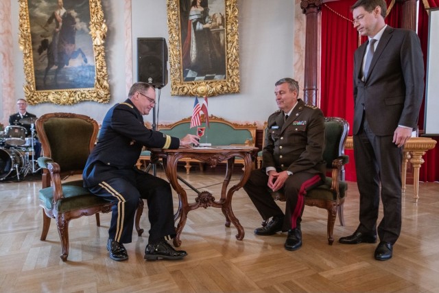 U.S. Army Maj. Gen. Paul Rogers, adjutant general of the Michigan National Guard, Lt. Gen. Leonīds Kalniņš, Latvian chief of defense, and Mārcis Vilcāns, chairman of the board for Latvia Post, perform a stamp canceling ceremony May 3, 2023, in Riga, Latvia, at an event honoring the 30th anniversary of Latvia’s defense cooperation with the Michigan National Guard under the State Partnership Program. The SPP has been instrumental in developing Latvia&#39;s defense capabilities