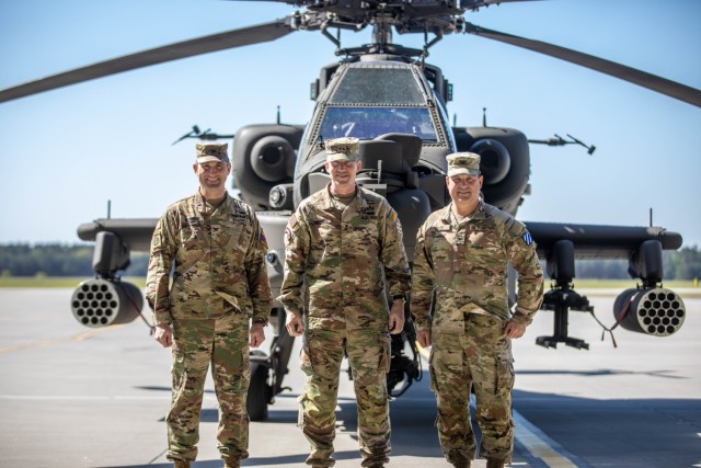 U.S. Army Col. John Morris, Commander, 1st Armored Division, Combat Aviation Brigade, left, Maj. Gen. David Hodne, Commander, 4th Infantry Division, center, and Col. Eric Kovak, Commander, 3rd Combat Aviation Brigade, 3rd Infantry Division, stand together in front of an AH-64E Apache after the transfer of authority ceremony at 33rd Air Base, Powidz, Poland, May 10, 2023. The 4th Infantry Division’s mission in Europe is to engage in multinational training and exercises across the continent, working alongside NATO allies and regional security partners to provide combat-credible forces to V Corps, America’s forward deployed corps in Europe. (U.S. Army photo by Spc. William Thompson)