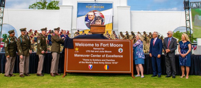 Fort Moore leaders along with members of the Moore family unveil the official Fort Moore sign during a redesignation ceremony May 11 held at the post’s historic Doughboy Stadium. 