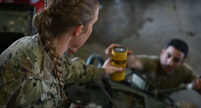 Sgt. Kathryn Daniels, a Stryker systems maintainer from the 3rd Cavalry Regiment works on an armored Stryker vehicle at Fort Cavazos, Texas in March 2023. 