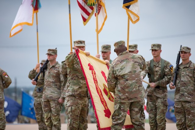 Col. Chad R. Foster and Command Sgt. Maj. Calvin Hall, command team fort Cavazos, unfurl the new Fort Cavazos flag during the Installation Redesignation Ceremony May 9, 2023, at III Armored Corps and Fort Cavazos Headquarters. (U.S. Army photo by Blair Dupre, Fort Cavazos Public Affairs)