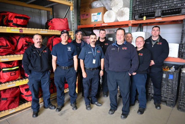 Members of the Tobyhanna Army Depot Fire and Emergency Services Branch pose for a photo in the newly organized firehouse equipment storage area.