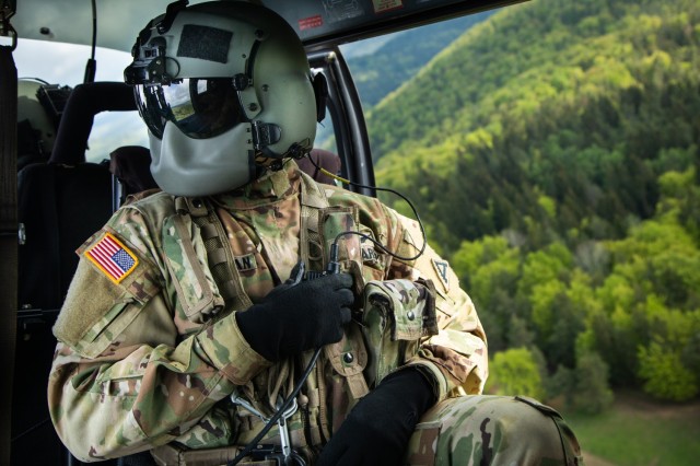 Spc. Logan Speakman, Joint Multinational Readiness Center Falcon team Crew chief, speaks over the radio with his team while inside a UH-72A Lakota during a Combined Resolve 18 in Hohenfels, Germany, May 5, 2023. Combined Resolve 18 is a U.S. Army Europe and Africa-directed combat training exercise for the U.S. Army’s 2nd Armored Brigade Combat Team, 1st Cavalry Division, as well as our NATO allies and partners.