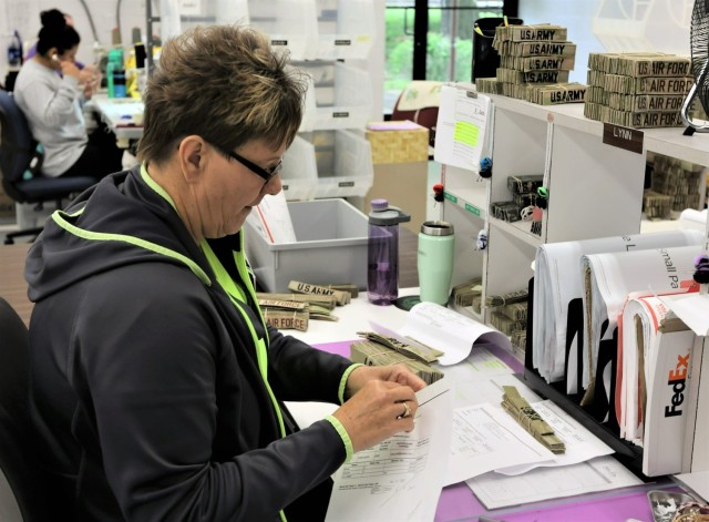 Lynn Markham, who is often referred to as “Hawkeye” by her co-workers at the Fort Knox Exchange Name Tape Plant, works May 9, 2023, on quality control and shipping products worldwide.