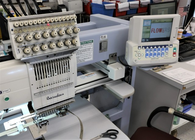 An automated embroidery machine prints a service member’s name onto camouflage tape May 9, 2023, at the Fort Knox Exchange Name Tape Plant.