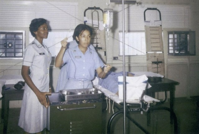 1st Lt. Clara Leach (left) instructs a student in intravenous therapy use during a medical-surgical nursing course at U.S. Army Medical Training Center, Fort Sam Houston, Texas, 1964.  She would go on to become the 18th Chief of the U.S. Army Nurse Corps.