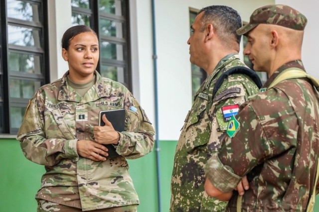 New York Army National Guard Capt. Stephanie Fernandez, commander of the 138th Public Affairs Detachment, speaks to a Paraguayan Army Soldier during a planning conference for Operation Parana held in in Foz do Iguazu, Brazil, on May 3, 20232. Operation Parana is a joint-training event that involves international participation to strengthen partnerships and improve interoperability in the event of a natural disaster in South America.
