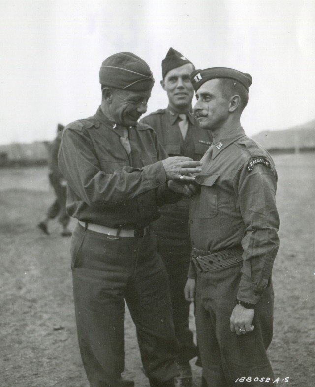 Brig. Gen. Theodore Roosevelt pins the silver Star on a captain from the 1st Ranger Battalion on January 4, 1944. 