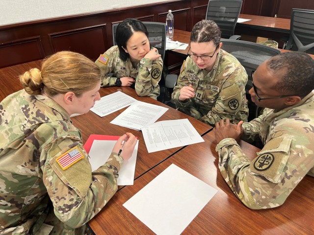 Small groups of officers and NCOs review the sustainment annex of an operations order early in the course to determine pharmacy requirements in preparation for deployment. This activity ensures appropriate and sufficient resourcing to support any type of field casualty event.
People from L to R: Sergeant Elizabeth Hunt (Pharmacy NCO, Blanchfield Army Community Hospital, Fort Campbell, KY), Capt Ji Yoon Kim (Pharmacy OIC, Walter Reed National Military Medical Center, Bethesda, MD), Capt Alexandra Castro (Pharmacy OIC, Martin Army Community Hospital, Fort Benning, GA), Sergeant Elijah Barrett (Pharmacy NCO, Bayne-Jones Army Community Hospital, Fort Polk, LA). (Courtesy photo).