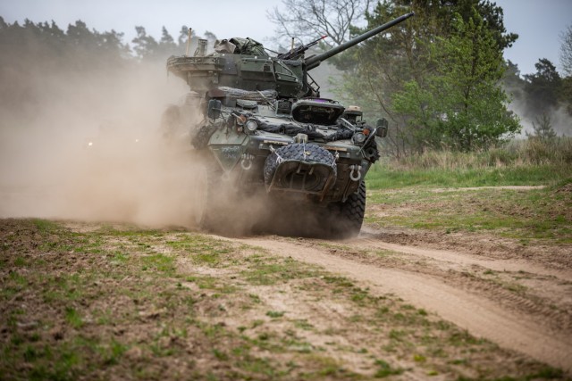 U.S. Soldiers assigned to Kronos Troop, 3rd Squadron, 2nd Cavalry Regiment, NATO Multinational Division Northeast, utilize a Stryker to advance on the simulated target during an Exercise Griffin Shock 23 live fire rehearsal training event in Bemowo Piskie, Poland, May 15, 2023. 
