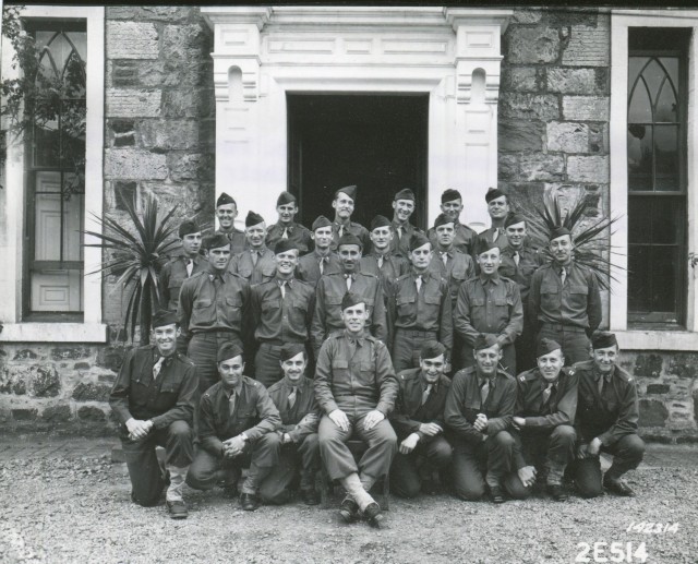 Officers from the U.S. Rangers Training Battalion pose in front of their quarters in Britain in July 1942. Lt. Col. William O. Darby, sits in front middle.