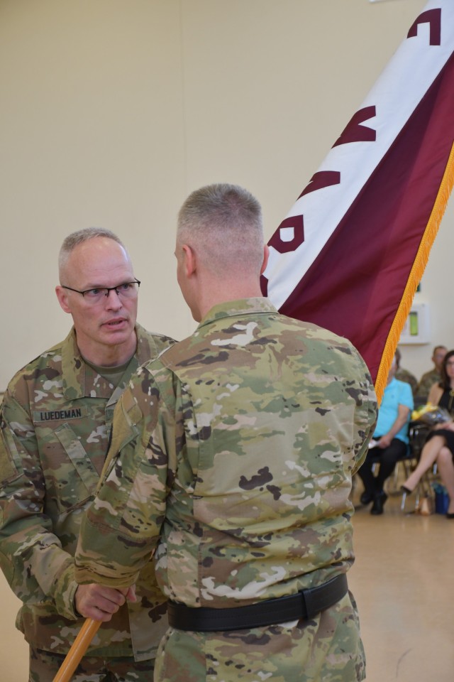 Col. Larry (Jeff) Luedeman, outgoing Central Medical Area Readiness Support Group commander, passes the CEMARSG Colors to Brig. Gen. Thad Collard, Army Reserve Medical Command Deputy Commanding General, at the CEMARSG change of command ceremony held at Fort Sheridan, Illinois May 7, 2023.