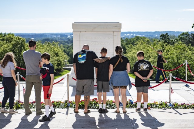Visitors participate in the first Flowers of Remembrance Day at the Tomb of the Unknown Soldier at Arlington National Cemetery, Arlington, Va., May 28, 2022. Visitors were given the opportunity to cross the plaza and place a flower in front of the...