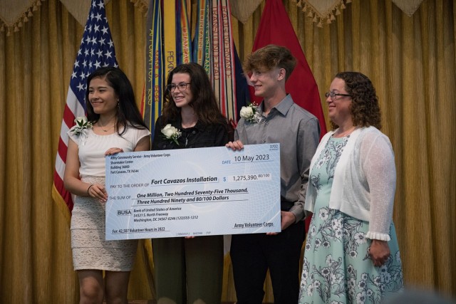 A check representing the monetary value of the more than 40,000 volunteer hours from 2022 is presented to Greta Buccellato, deputy to the Garrison commander. (U.S. Army photo by Blair Dupre, Fort Cavazos Public Affairs)