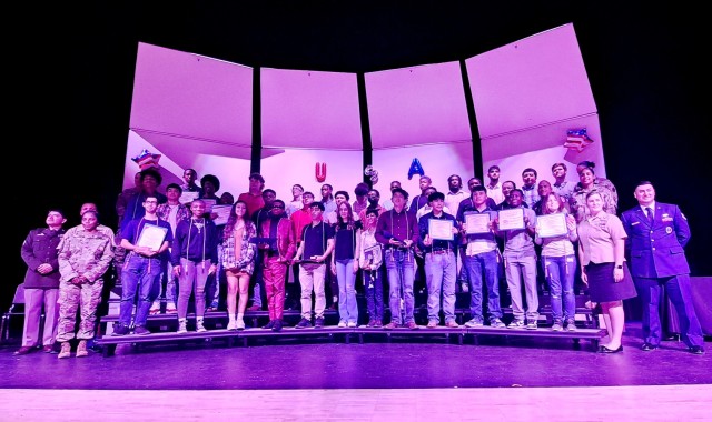 Students and recruiters pose for a photo at the end of the Military Enlistment Recognition Program at Shoemaker High School May 10. (U.S. Army photo by Janecze Wright, Fort Cavazos Public Affairs)