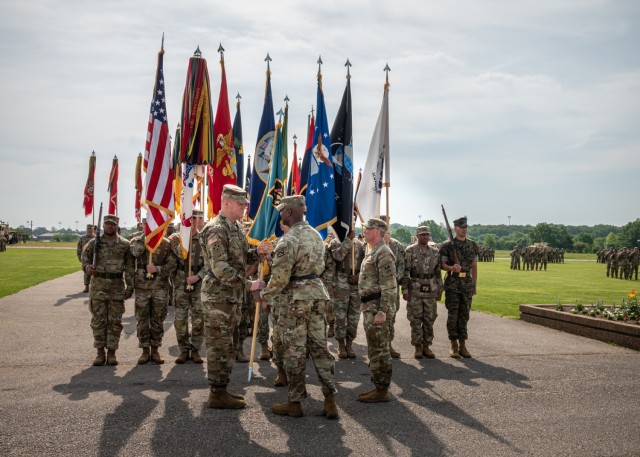 Incoming Maneuver Support Center of Excellence and U.S. Army Fort Leonard Wood Commanding General Maj. Gen. Christopher Beck (left) takes the colors from Lt. Gen. Milford Beagle Jr., U.S. Army Combined Arms Center commanding general, during a ceremony held this morning on Gammon Field.