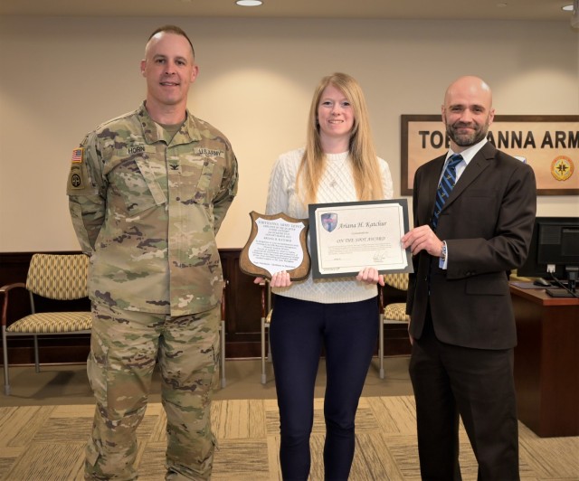 Depot Commander Colonel Daniel L. Horn and Deputy Commander Rob Lantka present the Employee of the Quarter, Junior Category award to Accountant Ariana Katchur.