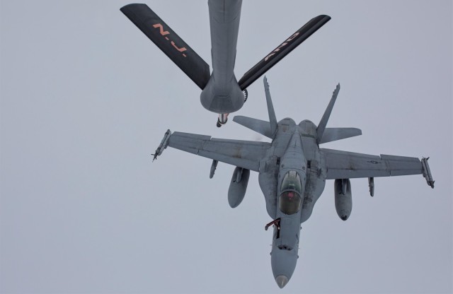 A U.S. Marine Corps F/A-18C Hornet with Marine Fighter Attack Squadron 115 &#34;Silver Eagles&#34; flies behind a U.S. Air National Guard KC-135R Stratotanker with New Jersey’s 141st Air Refueling Squadron “Tigers” during exercise Scarlet Dragon on Oct. 7, 2021. The Scarlet Dragon exercise was led by the XVIII (Airborne) Corps and included observers from the UK, Australia and Canada as well as participants from all six U.S. armed services. 