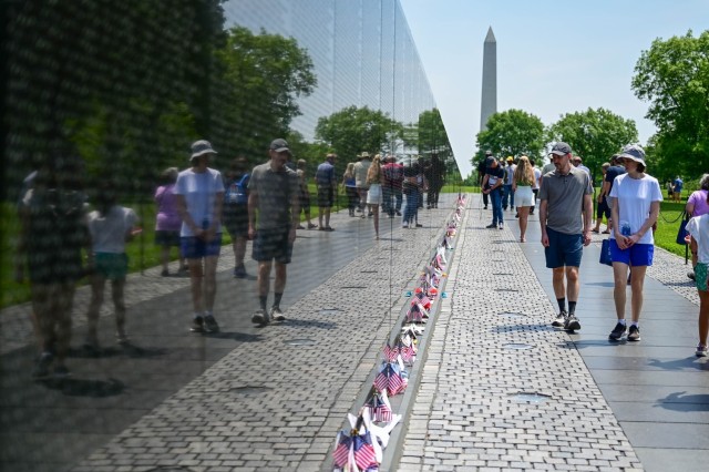 Visitors to the Vietnam Veterans Memorial in Washington, D.C. walk the length of the wall March 11 and observe the more than 58,000 names engraved on the wall. The memorial is the most visited memorial on the Washington, D.C. Mall with more than 5 million visitors every year.