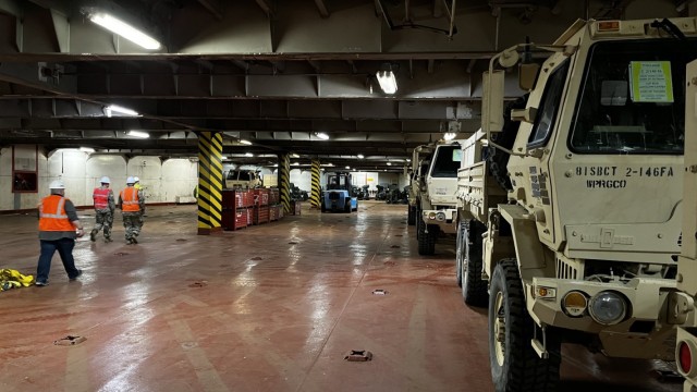 Vehicles from 2nd Battalion, 146th Field Artillery Regiment, Washington National Guard, sit in the loading bay of a cargo ship as it is being loaded for travel to the Kingdom of Thailand prior to Hanuman Guardian 23 on May 23, 2023, at the Port of...