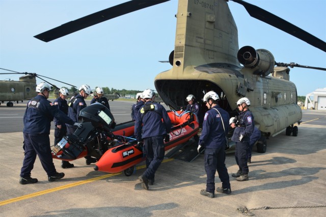 Members of the Montgomery County Urban Search and Rescue Team practice loading a rescue boat and equipment into a CH-47 Chinook helicopter from Bravo Company, 2-104th General Support Aviation Battalion, 28th Expeditionary Combat Aviation Brigade, May 18, 2023, at Fort Indiantown Gap, Pa. The training was part of an extreme weather exercise coordinated by the Pennsylvania Emergency Management Agency. 