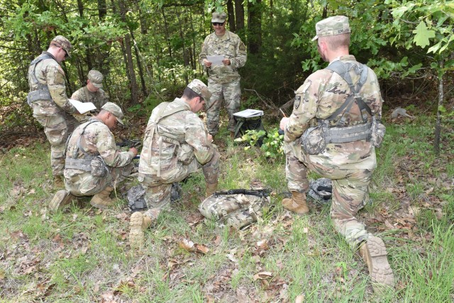 Capt. Nelson Tillman, the officer in charge of the Show-Me Guard Officer Leadership Development, or GOLD, program at Southeast Missouri State University in Cape Girardeau, reads the situational tactical exercise operation order to Missouri Army National Guard officer candidates May 18 at Training area 190. About 30 Missouri National Guard Soldiers in the Show-Me GOLD program trained here this month. 