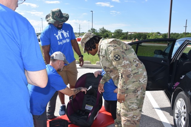 Pfc. K&#39;Terri Miller, 13th Armored Corps Sustainment Command, listens as volunteers from the Family Advocacy Program explain the proper way to use a child car seat. Miller was surprised to learn that one of her car seats was expired, but FAP volunteers made sure she left with a new one May 19, 2023, at Fort Cavazos. (U.S. Army photo by Janecze Wright, Fort Cavazos Public Affairs)