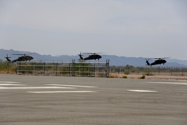 Black Hawk Helicopters from Alpha Company, 5th Battalion, 101st Aviation Regiment, take off for an air assault mission during Experimental Demonstration Gateway Event (EDGE) 23 in Yuma, Arizona.