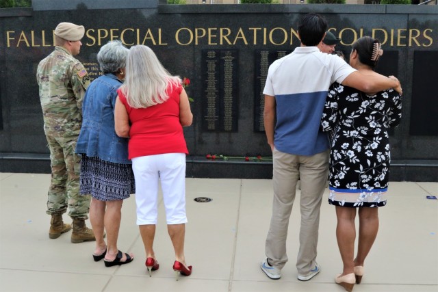 Gold Star family members gaze upon the Memorial Wall at the U.S. Army Special Operations Command Headquarters following the annual Gold Star Memorial Day Ceremony on Fort Bragg, N.C., May 25.