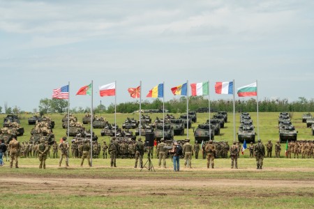 Soldiers and armored vehicles are staged for the opening ceremony for exercise Saber Guardian 23 in Smardan, Romania, May 29, 2023. 