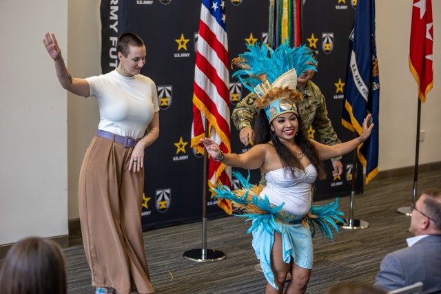 Army Futures Command staff members join the Hiti Mahana Polynesian performance group in a traditional dance during the command’s Asian American Pacific Islander Heritage Month observance in Austin.