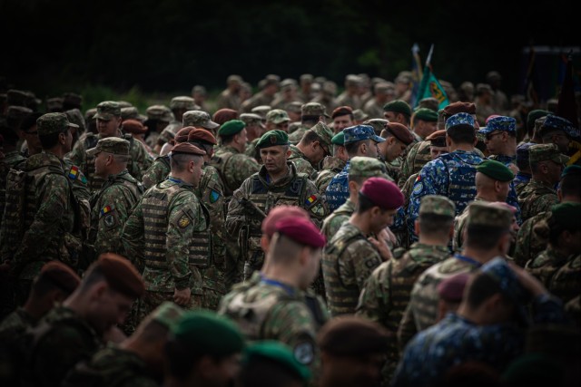 Romanian military service members mass during opening ceremony of Saber Guardian