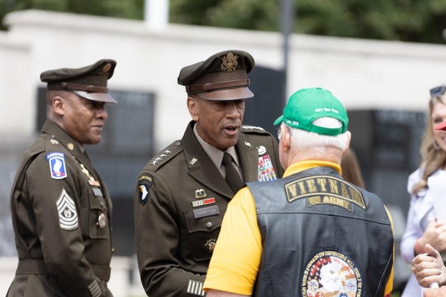 Gen. Charles Hamilton, commander of Army Materiel Command, shakes hands Monday with retired Capt. Mike Rose, a Medal of Honor recipient, during Huntsville’s Memorial Day Ceremony and Laying of Wreaths at the Huntsville Madison County Veterans Memorial. 