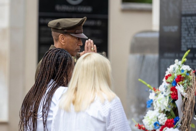 Gen. Charles Hamilton, commander of Army Materiel Command, assists two Gold Star mothers in laying a wreath honoring mothers whose children died while serving in the armed forces. 